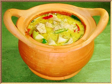 A photo of a delicious looking Thai Green Chicken Curry, in an earthen ware cooking pot.